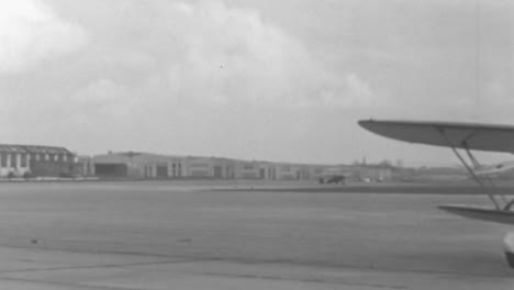 Vintage-Airplane-Parked-on-the-Runway-on-a-Sunny-Day-in-New-York-in-1930s