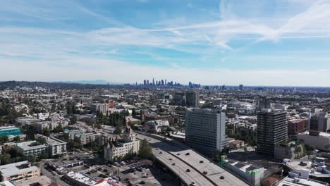 Drone-aerial-view-of-Los-Angeles,-California-with-traffic-and-skyline