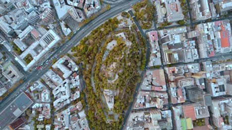 Santa-lucía-hill-amidst-santiago's-urban-landscape,-daylight,-aerial-view