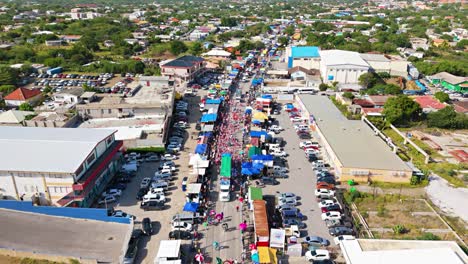 Aerial-tilt-up-to-panoramic-view-of-Carnaval-Grand-March-parade-in-Willemstad-Curacao