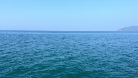 Beautiful-drone-view-of-blue-ocean-and-warm-blue-sky-Goa-India-dolphine