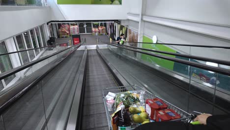 Descending-on-the-walkway-or-travelator-within-a-London-supermarket,-England