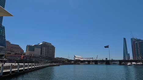 Blue-skies-over-Darling-Harbour-with-a-panning-view-from-the-convention-center-to-the-W-Hotel,-sunny-day