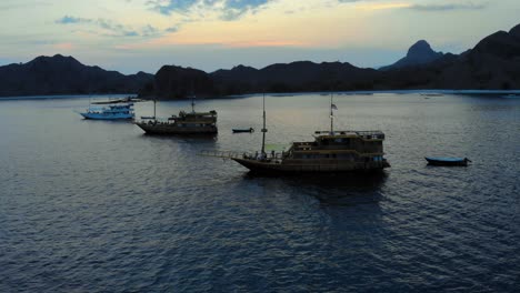 Traditional-Wooden-Tour-Boats-anchored-off-the-coast-of-Padar-Island,-near-Komodo-in-Indonesia