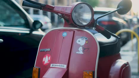 Rotating-Panning-view-of-Italian-Vespa-Moped-on-Crowded-Street-on-a-Sunny-Day