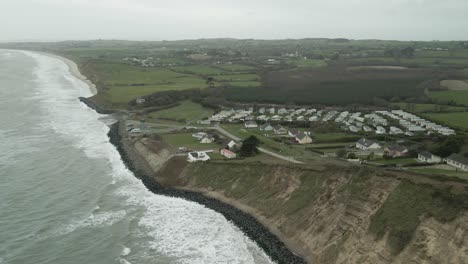 Coastal-holiday-village-in-Wexford-under-cloudy-skies,-stormy-weather-conditions,-aerial-shot