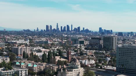 Drone-shot-flying-towards-downtown-los-angeles,-California-during-a-sunny-day