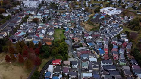 A-dense-residential-area-with-varied-roof-colors-on-an-overcast-day,-autumn,-aerial-view