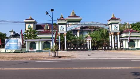 Pov-of-the-atmosphere-in-front-of-the-gate-of-the-Gontor-Putri-1-modern-Islamic-boarding-school,-Ngawi,-East-Java,-Indonesia