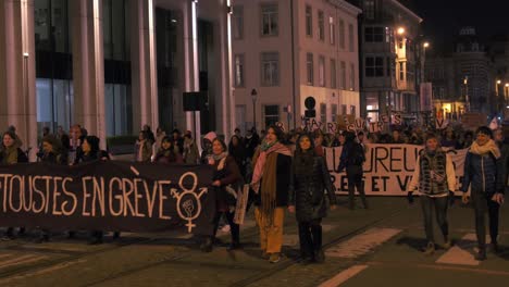 Demonstrators-carry-'En-Greve'-sign-in-twilight-women's-rights-march