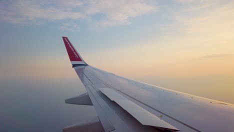 Wing-of-Norwegian-airplane-and-blurry-horizon-seen-through-window