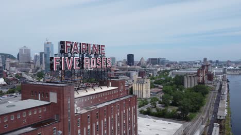 aerial-of-The-Farine-Five-Roses-sign-on-top-of-skyscraper-building-,-a-feature-of-the-Montreal-skyline