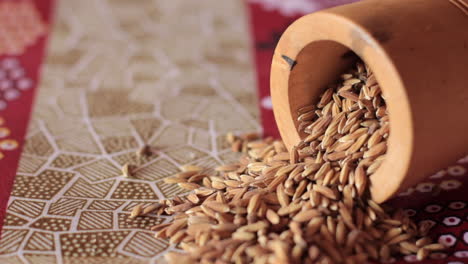 Close-up-of-unhusked-rice-African-dashiki-cloth-backdrop