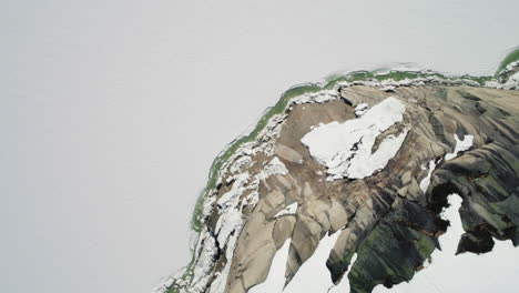 Snow-covered-mountain-and-frozen-lake-in-Switzerland