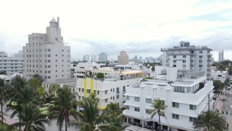 Miami-Beach-Ocean-Drive-Buildings,-Hotels-and-Palm-Trees-in-Park,-Drone-Aerial-View---Florida-USA
