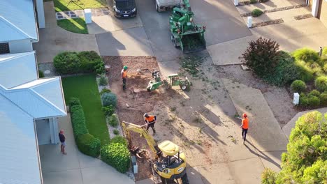 Yarrawonga,-Victoria,-Australia---6-March-2024:-Stump-grinder-working-on-a-stump-and-throwing-out-saw-dust-and-wood-pieces-in-a-suburban-street