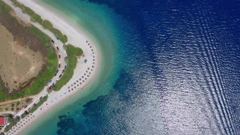 Aerial:-Top-down-drone-shot-of-the-beautiful-beach-at-Agios-Dimitrios,-Alonnisos-island,-Sporades,-Greece,-with-emerald-and-turquoise-sea