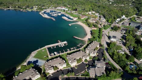 Drone-shot-overlooking-sister-bay,-Wisconsin-on-a-sunny-day-with-blue-water