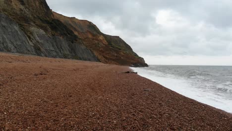 Aerial-low-flying-forward-shot-over-the-beach-showing-the-Major-2023-Landslip-at-Seatown-Dorset-England