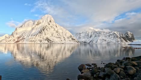 Olstinden-and-Festhaeltinden-in-Lofoten-at-calm-winter-day,-reflections-in-gently-moving-sea-surface