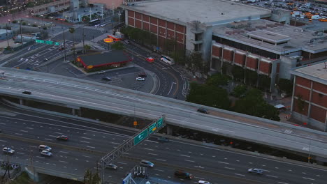 An-ambulance-rushing-to-an-emergency-in-a-busy-city--aerial-follow