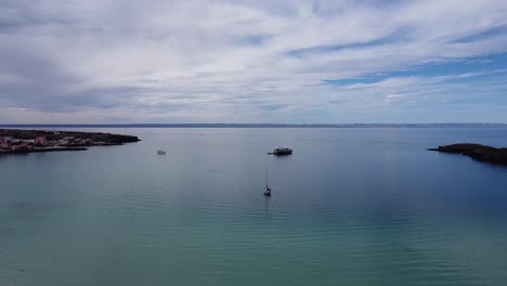 Baja-california's-playa-balandra,-tranquil-azure-waters-meeting-a-serene-beach,-aerial-view