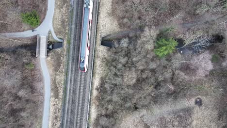 Aerial-view-of-train-gliding-through-Swiss-landscape