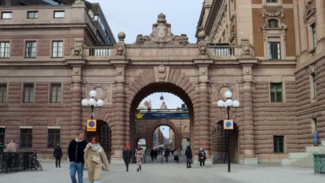 People-walk-by-Swedish-Parliament-building-in-Stockholm,-Sweden