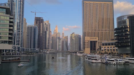 Dubai-Marina-at-Evening,-Modern-Skyscrapers,-Boats-and-Yachts-in-Canal-Wide-View