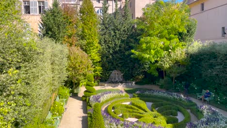 Bird-flies-at-Hotel-de-Caumont-garden-in-Aix-en-Provence-in-France