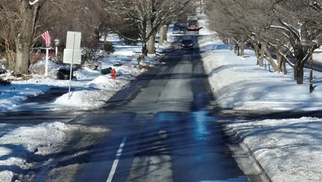 Aerial-view-of-cars-on-scenic-road-in-american-neighborhood-during-sunny-day