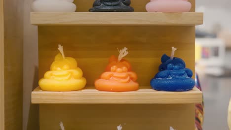 Playful-poop-emoji-candles,-colorful-shelf-decor