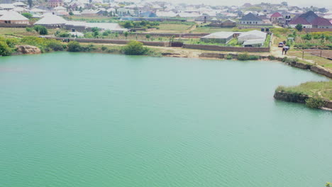 Natural-dam-in-the-countryside-near-Jos,-Nigeria---aerial-parallax