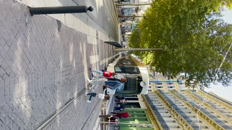 Family-holding-hands-while-crossing-street-in-Marseille,-vertical