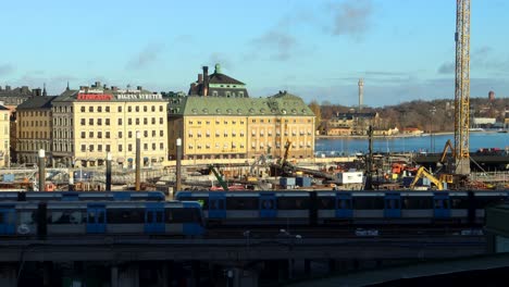 Two-subway-trains-pass-by-construction-site-at-Slussen-in-Stockholm