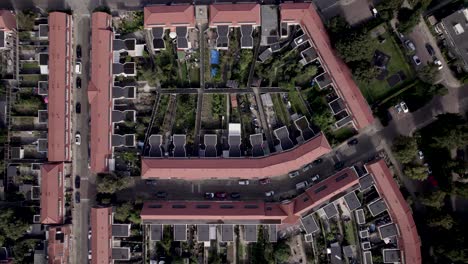 Red-tiled-rooftops-of-residential-neighbourhood-Noordveen-top-down-aerial-in-Zutphen,-The-Netherlands