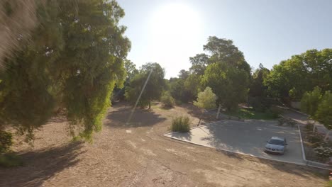 Daytime-aerial-shoot-passing-over-spa-garden-trees-in-Marmolejo-Spa-complex-located-in-Jaén-province,-Andalusia,-southern-Spain