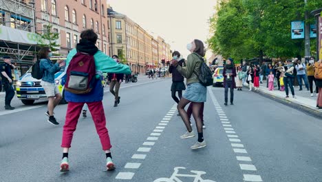 Protesters-dance-on-road-at-climate-demonstration-in-Stockholm,-slo-mo