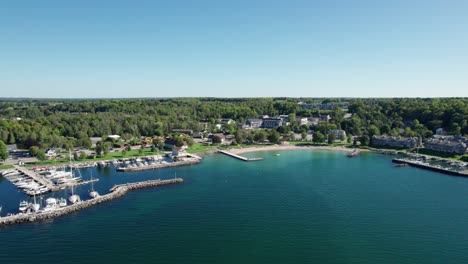 Distant-drone-shot-of-the-turquoise-colored-water-in-sister-bay,-wisconsin
