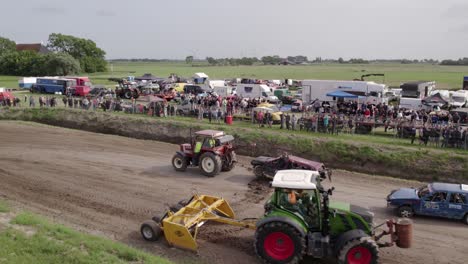 Aerial-view-of-old-cars-racing-on-dirt-track,-Friesland,-Netherlands