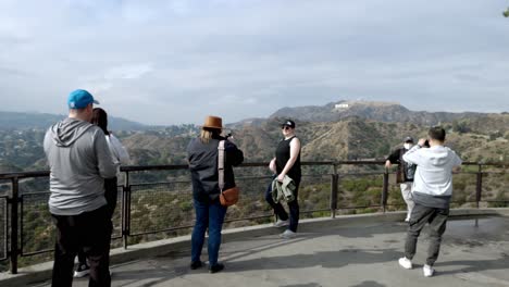 Tourists-with-the-Hollywood-sign-in-the-background-with-video-panning-right-to-left