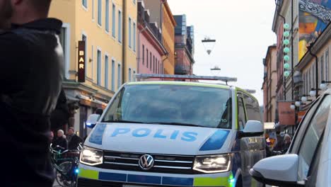 Slomo-shot-of-Police-van-with-sirens-on-at-protest-march-in-Sweden