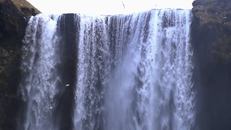 Aerial-Drone-View-Of-Massive-Waterfall-in-Wintery-Iceland,-Land-Of-Fire-And-Ice