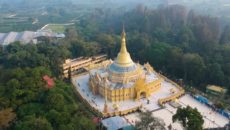 Aerial-of-Buddhist-temple-with-golden-pagoda-in-Lumbini-Natural-Park-or-Taman-Alam-Lumbini-in-Desa-Dolat-Rayat,-Berastagi-in-North-Sumatra,-Indonesia
