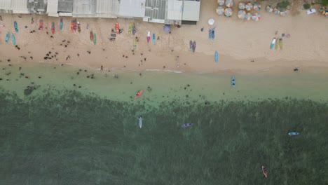 Top-down-view-of-people-enjoy-vacation-on-the-white-sand-beach