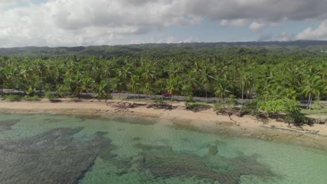 Aerial-Tracking-of-Car-Driving-by-Seaside-Road,-Las-Terrenas,-Dominican-Republic