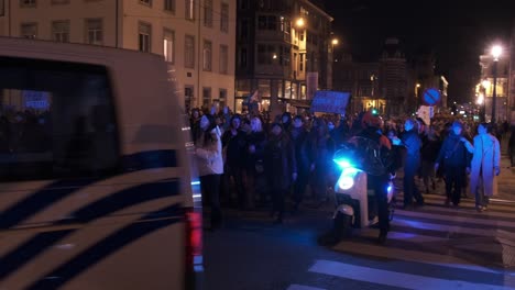 Nighttime-women's-march-with-police-car-in-foreground