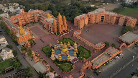 La-Cámara-De-Vista-Aérea-De-Drones-Está-Funcionando-Detrás,-Hay-Muchas-Casas-Detrás-Del-Templo-Y-Un-Templo-Grandioso-Y-Muy-Hermoso.