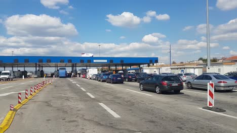 Serbian-Border-Crossing-at-Summer,-Heavy-Traffic-and-Long-Queue-of-Vehicles-Waiting-In-Line,-Panorama
