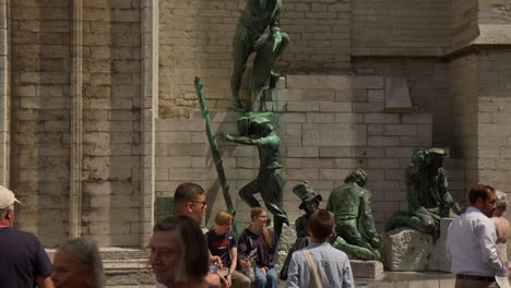 Artwork-Adorning-the-Wall-of-the-Cathedral-of-Our-Lady-in-Antwerp,-Belgium---Pan-Down-Shot